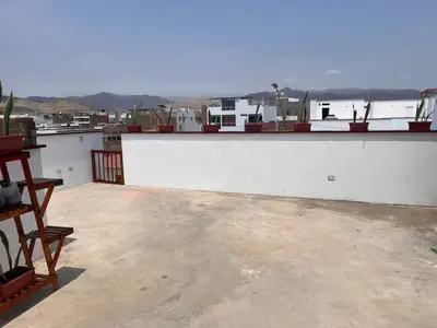 a view of a white building with a roof at Casa de playa con piscina 2 in Punta Negra