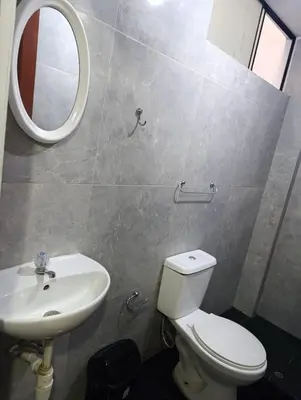 a bathroom with a toilet and a sink and a mirror at Hospedaje Dajoka's in Lima