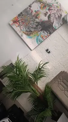 a plant sitting next to a keyboard and a painting at Hospedaje Dajoka's in Lima
