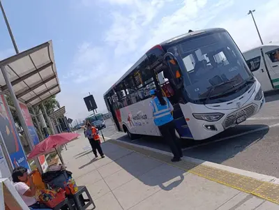 a person standing next to a bus at a bus stop at Hospedaje Dajoka's in Lima
