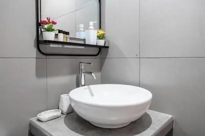 a bathroom with a white sink and a mirror at Equipped Loft with Sofa Bed and Balcony in Lima