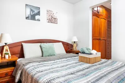 a bedroom with a bed with a wooden headboard at Equipped Loft with Sofa Bed and Balcony in Lima