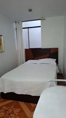 a bedroom with two beds and a window at Lindo Atardecer in Ica