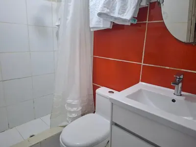a bathroom with a white toilet and a sink at Lindo Atardecer in Ica