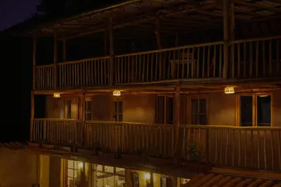 a building with a balcony at night at Unu Samay Lodge in Urubamba