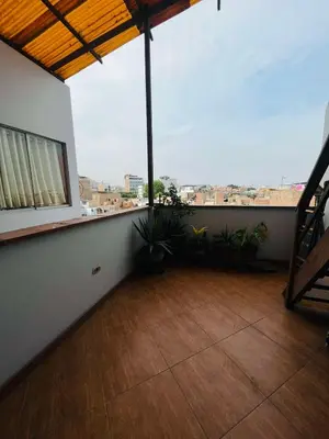 a room with a balcony with plants and a window at Las palmeras in Lima