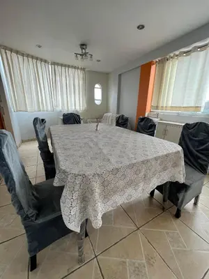 a dining room with a table and some chairs at Las palmeras in Lima