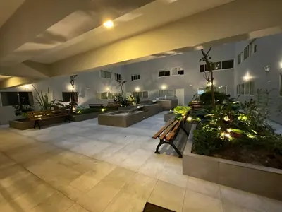 a large room with benches and plants in it at Oceanfront apartment, Pool, Gym, Sauna, Arcade in Lima