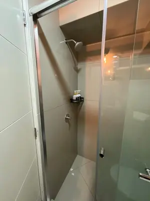 a shower with a glass door in a bathroom at Oceanfront apartment, Pool, Gym, Sauna, Arcade in Lima