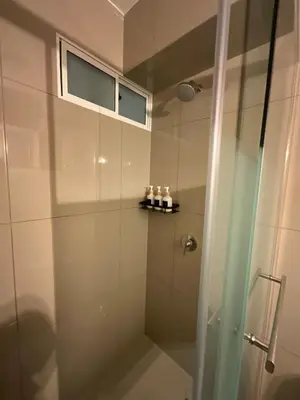 a bathroom with a shower with a glass door at Oceanfront apartment, Pool, Gym, Sauna, Arcade in Lima