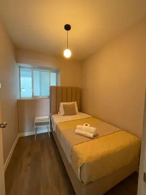 a small bedroom with a bed and a window at Oceanfront apartment, Pool, Gym, Sauna, Arcade in Lima