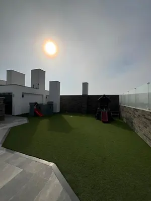 a large yard with green grass on the side of a building at Oceanfront apartment, Pool, Gym, Sauna, Arcade in Lima