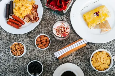 a table with plates of food and bowls of food at Sarapampa punto Asia in Asia