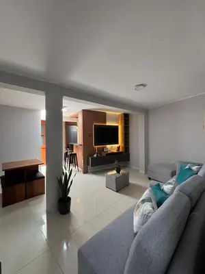 a living room with a couch and a television at Central and brand new apartment in Huamanga in Ayacucho