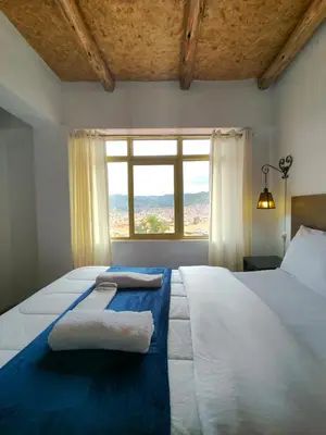 a bedroom with a large bed with towels on it at Imperial City Apartment in Cusco
