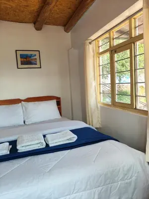 a bedroom with a bed with two towels on it at Imperial City Apartment in Cusco
