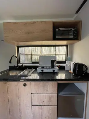 a kitchen with a counter top with a printer on it at Tiny Mountain River in Urubamba