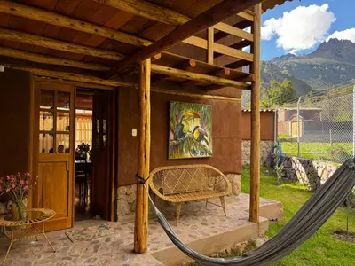 a porch with a hammock in a house at Casa Nuestra in Urubamba
