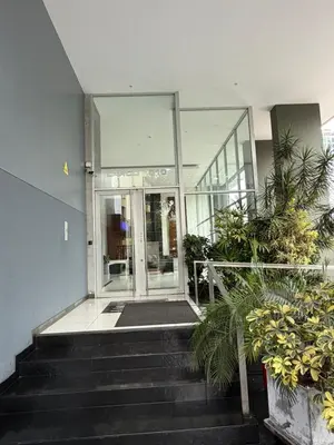 a building with stairs leading to a glass door at Duplex en miraflores av larco 1010 in Lima
