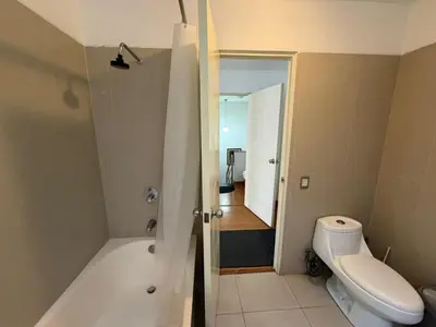 a bathroom with a tub and a toilet and a sink at Duplex en miraflores av larco 1010 in Lima