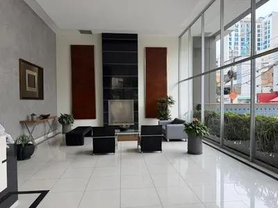 a lobby of a building with chairs and a tv at Duplex en Miraflores av larco 1010 in Lima