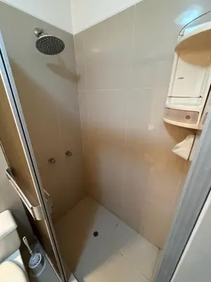 a shower with a glass door in a bathroom at Duplex en Miraflores av larco 1010 in Lima