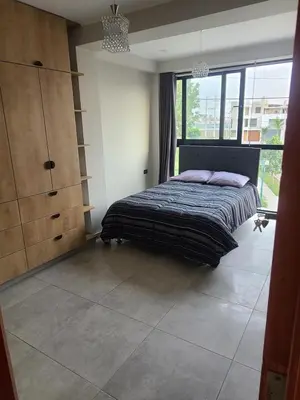 a bedroom with a bed and a large window at Departamento en ica de estreno in Ica