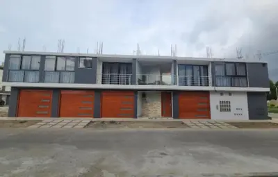 a large house with orange doors and windows at Departamento en ica de estreno in Ica
