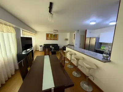 a kitchen and dining room with a table and chairs at Apartamento con ascensor en segundo piso, Miraflores in Lima