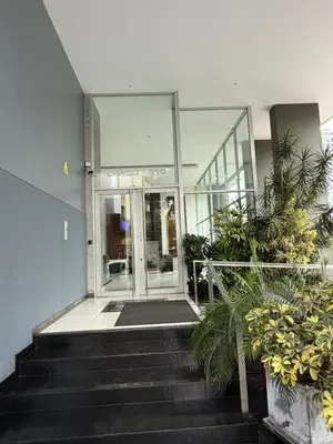 a lobby of a building with stairs and plants at Apartamento con ascensor en segundo piso, Miraflores in Lima
