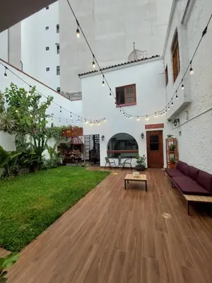 a living room with a couch and a table at Casa Cayena in Lima