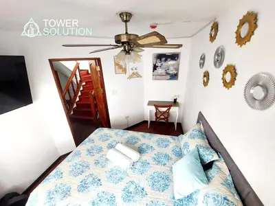 a bedroom with a bed and a ceiling fan at Casa Cayena in Lima