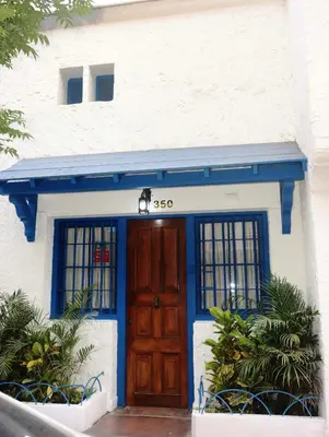 a blue and white building with a door at Casa Cayena in Lima