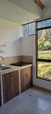 an empty kitchen with a sink and a window at Florez de la Villa Apart Hotel in Cusco