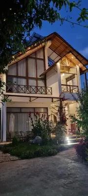 a house with a balcony on the side of it at Florez de la Villa Apart Hotel in Cusco
