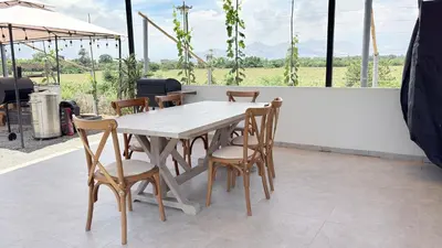 a wooden table and chairs on a patio at Casa San José - Bungalow 5 in Ica