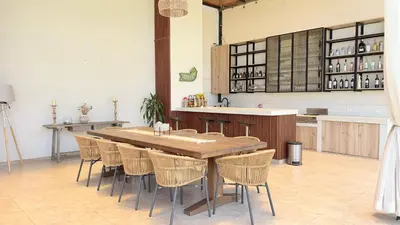 a kitchen with a large wooden table and chairs at Casa San José - Bungalow 5 in Ica