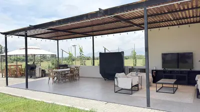 a pergola with a table and chairs on a patio at Casa San José - Bungalow 5 in Ica