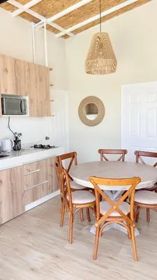a dining room with a table and chairs in a kitchen at Casa San José - Bungalow 5 in Ica