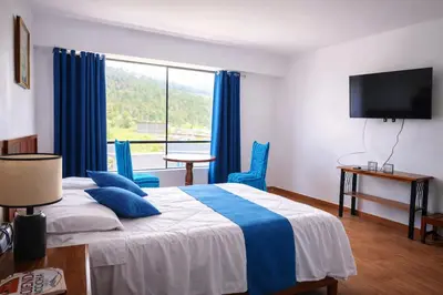 a bedroom with a bed and a large window at Mi Hacienda Pacucha in Andahuaylas