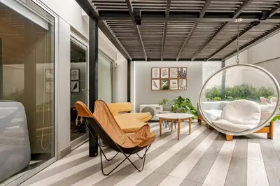 a living room with a chair and a mirror at Barranco apartment facing the ocean in Lima