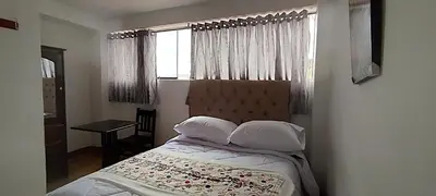 a bedroom with a bed and a window at Hospedaje Tikari in Chinchero