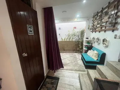 a hallway with a blue couch and a window at Ministery The Bleasing in Lima