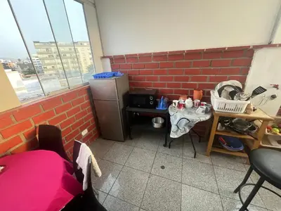 a kitchen with a brick wall and a small refrigerator at Ministery The Bleasing in Lima