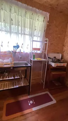 a kitchen with a sink and a window in a room at Cabañas Vivenciales La Colina in Oxapampa