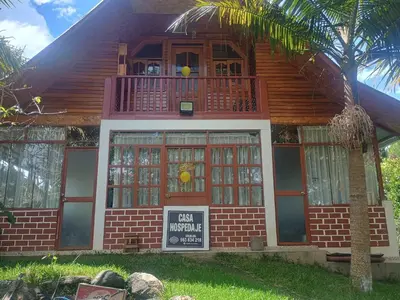 a small house with a sign in front of it at Cabañas Vivenciales La Colina in Oxapampa