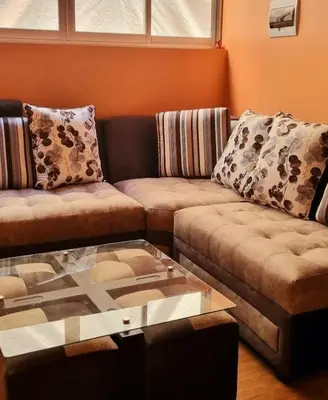 a living room with two couches and a glass table at Cusco Apartment Prime Location in Cusco