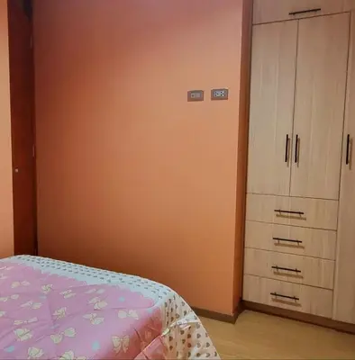 a bedroom with a bed and a dresser at Cusco Apartment Prime Location in Cusco