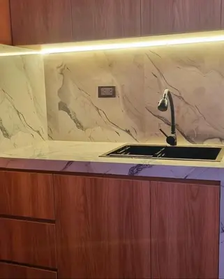 a kitchen sink with a marble counter top at Cusco Apartment Prime Location in Cusco