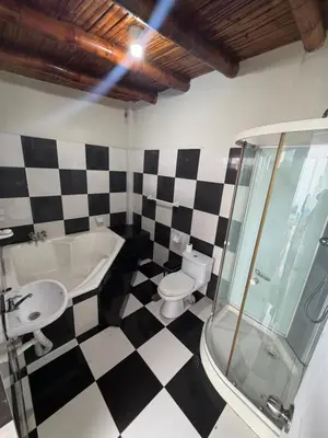 a bathroom with a black and white checkered floor at Casa de playa in Arica